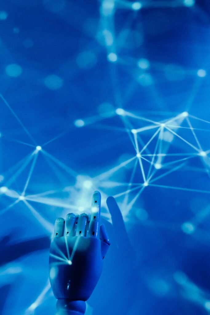 Robotic hand reaching toward a glowing neural network, representing AI assistants like Google Gemini